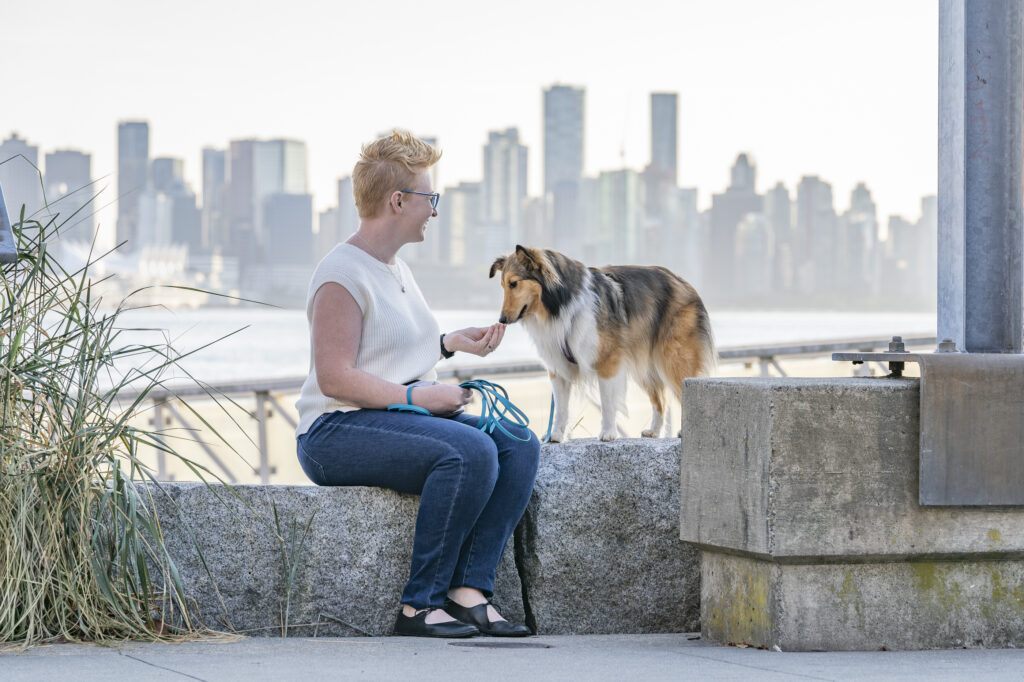 Kaeli Grotz with sheltie Freya with city view of Vancouver